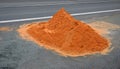 On the street lies a folded pile of sand or red clay. repair of the road of the house backfill gas power line, or reconstruction o