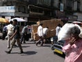 Street life in Mumbai India - men pushing cart loaded with boxes