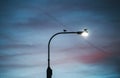 A street light against cloudy twilight background.