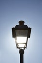 Street light on blue sky illuminated by the sun Royalty Free Stock Photo