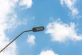 Street light with halogen lamp against blue sky