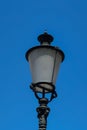 Street light pole against sunny summer blue sky and skatter white clouds, Close up telephoto shot, no people Royalty Free Stock Photo