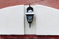 Street light in shape of lantern on stone wall Royalty Free Stock Photo