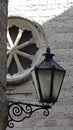 street light on a stone wall in front of a circular marble window, Kotor, Montenegro Royalty Free Stock Photo