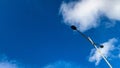 Street light under bright blue sky with white clouds Royalty Free Stock Photo