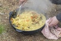 Street lighting. fire. a cooking pot. ready pilaf. close-up