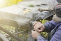 Street lighting. a masked worker processes a granite stone with a special tool. Close-up Royalty Free Stock Photo