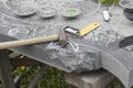 Street lighting. a masked worker processes a granite stone with a special tool. Close-up Royalty Free Stock Photo