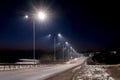 Street lighting, supports for ceilings with led lamps. concept of modernization and maintenance of lamps, place for text, night. Royalty Free Stock Photo