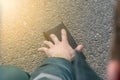 Street lighting. there is a wallet on the road on a sunny summer day. A human hand reaches out to him Royalty Free Stock Photo