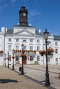 Street lights with flowers in front of the town hall in Plock Royalty Free Stock Photo