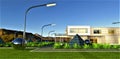 Street lights line the pedestrian path in a futuristic eco-friendly estate with solar panel pyramids and whimsical metal