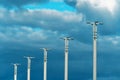 Street lights. Pillars of city lighting against a cloudy sky. Daytime Royalty Free Stock Photo