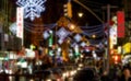 Street lights shining in busy night street scene in Chinatown New York City with blur effect Royalty Free Stock Photo