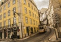 A street in Lisbon, Portugal. Tram and a yellow building.