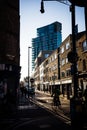 Street in London Eastend in evening light with a passing cyclist.