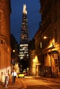 Street of London at night. The Shard of Glass skyscraper built in Neo futurism architectural style.