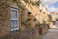 Street with low houses in a row, with characteristic windows and Royalty Free Stock Photo