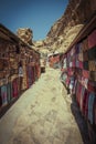 street with market in the ancient city of Petra in Jordan with souvenir products, fabrics and carpets with national Bedouin ornam