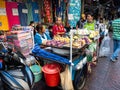 Street market selling food and clothes with three ladies talking in Bangkok, Thailand Royalty Free Stock Photo