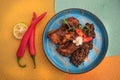 Street mexican food on the table. Braised ribs and beans. Top view. Microgreens, pepper and lime.