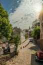 Street of Montmartre with people, buildings and trees at Paris.