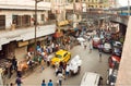 Street movement with cars, trader trolleys and crowd of people in huge asian city