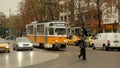 Street with moving traffic and pedestrians in Sofia, Bulgaria, weekday city life