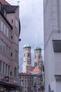 At the street in Munich. Between houses two towers of Frauenkirche