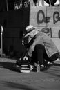 Street musician in a hat unpacking his guitar in Duesseldorf, Germany