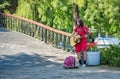 Street musician man playing at an acoustic guitar in King Mihai I park ( Herestrau), in Royalty Free Stock Photo