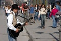 Street musician on the street in Novi Sad, Serbia, entertains passers-by around him