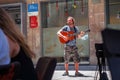 Street musician at an open restaurant in the center of Barcelona