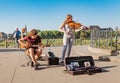 Street musician performing music for donating money and coins Royalty Free Stock Photo