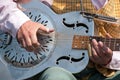 Street musician playing a dobro guitar