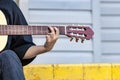 A street musician plays the guitar. Close-up of hands plucking chords. Guitar neck Royalty Free Stock Photo