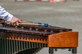 A street musician plays marimba. The guy hands plays on the marimba on the street Royalty Free Stock Photo