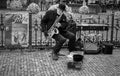 Street musician plays saxophone in Prague, Czech Republic. Black and white