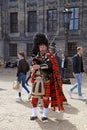 Street musician with Scottish traditional bagpipes Royalty Free Stock Photo