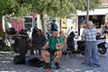 Street musician singing and playing Cretan lyra, traditional Greek music instrument.