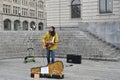 Street musician singing and playing guitar in centrum of city during Christmas market.