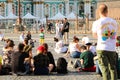 Street musician in the square, people listen to music.