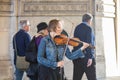 Street musician under an archway to the Louvre, Paris.