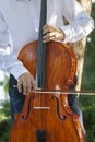 Street musician, young man playing cello in the street of big city, close up Royalty Free Stock Photo