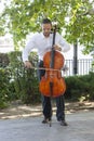 Street musician, young man playing cello in the street of big city, close up Royalty Free Stock Photo