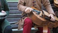 Street musicians dressed in vintage ethnic oriental clothes play music on traditional Middle Eastern musical instruments