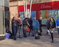 Street musicians or entertainers playing trumpets.