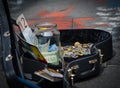 Street Musicians money in different currencies in the guitar case.