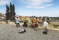 Street musicians play for tourists on the Charles bridge in Prague.