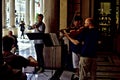 Street musicians playing classical music in the shade.